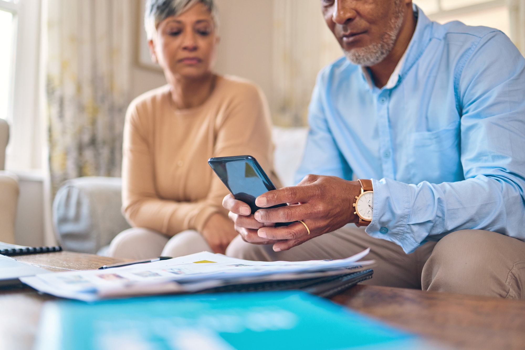 Retirement paperwork, admin and a couple with a phone for finances, bills or home insurance. Docume