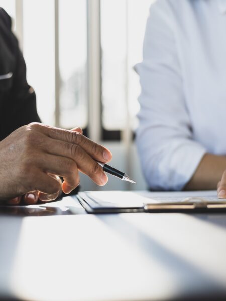 Businessman showing an insurance policy to sign. Insurance agent consulting insurance to customer.